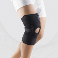 Det medisinske neoprenkne kne-båndet, med åpning for knappe, vårinnsetting, universal. LUKS